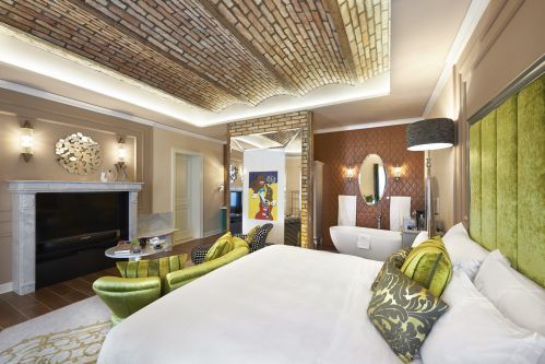 Aria Signature Rooms with 1 King bed feature a 55" flat screen presented in a marble fireplace mantle.